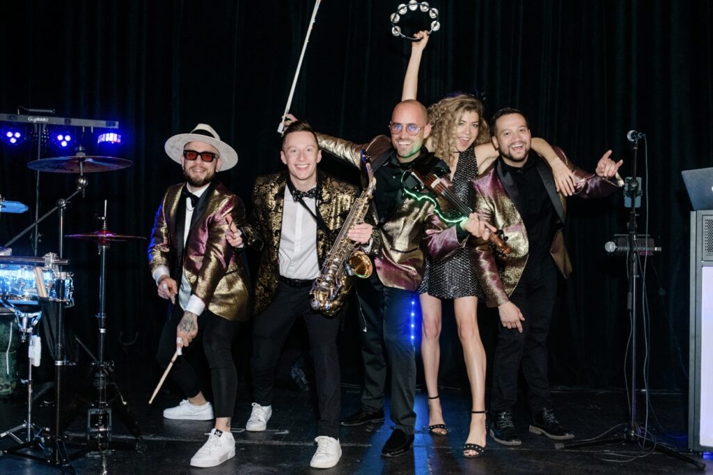 Wedding Hybrid DJ group with saxophone player, electric violinist, percussionist, and vocalist performing in Charleston, SC at the American Theater | Charleston Virtuosi